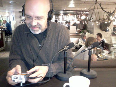 Picture of Jon Buscall and audio equipment in a cafe