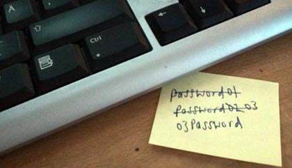 Post-it note with a password written on it half hidden under a keyboard