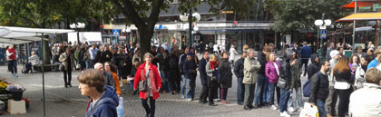 Long queue of people outside an electronics store in Stockholm